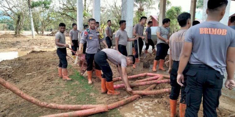 Brimob Polda Sumut Bersihkan Aula SMP Santo Fransiskus Pandan Pascabencana Lumpur